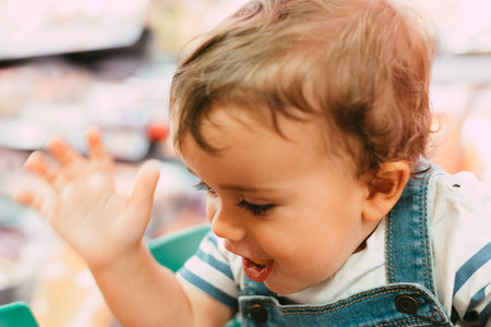 close-up of 18-month-old child in supermarket with unfocused background