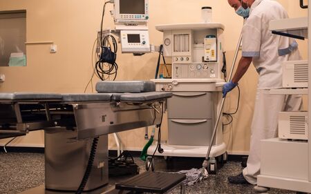 Cleaning staff cleaning the operating roomの写真素材