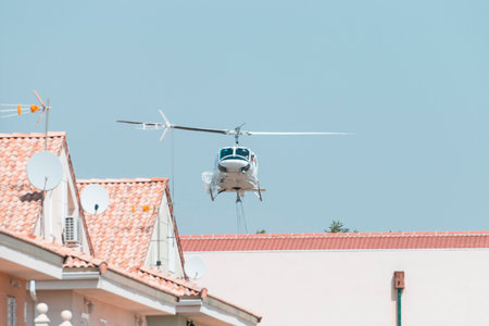 fireman's helicopter carrying water into the pool