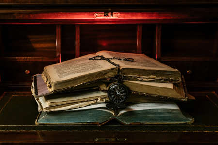 open book with candlelight, incorporates a camera, clock and a cup of coffeeの写真素材