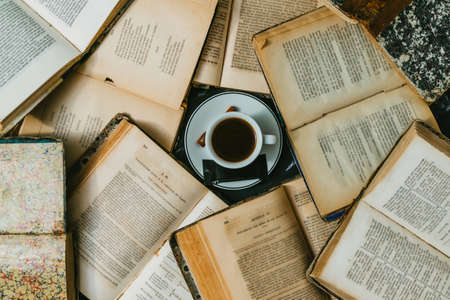 open book with candlelight, incorporates a camera, clock and a cup of coffeeの写真素材