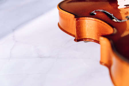 Violin parts. Bow first on white marble background. Selective focus.の写真素材