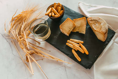 Cured Manchego cheese with bread and white wine. Focus selective.の写真素材