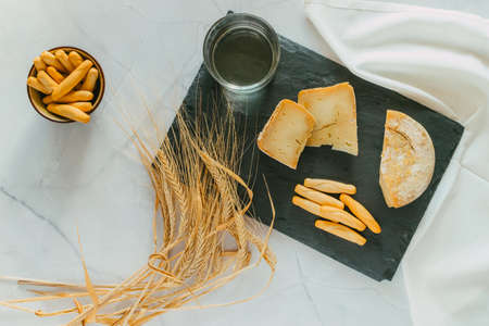 Cured Manchego cheese with bread and white wine. Focus selective.の写真素材
