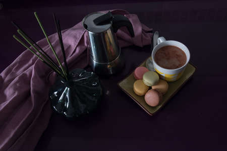 dark food. Colored cookies with a cup of cocoa on a dark purple background.の写真素材