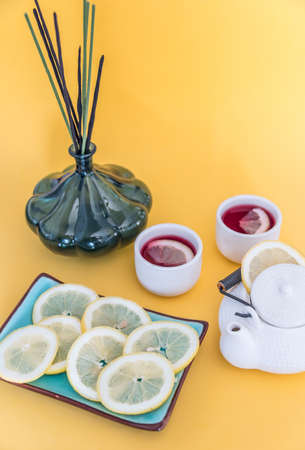 Red tea with lemon on a yellow backgroundの写真素材