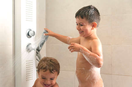 two kids playing in a bubble bathの写真素材
