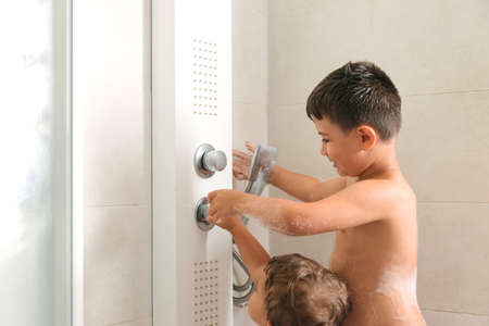 two kids playing in a bubble bathの写真素材