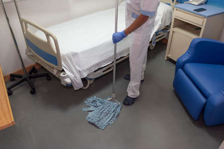 Cleaning staff cleaning hospital roomsの写真素材