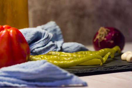 Still life snacks, tapas, chilli peppers, garlic, tomatoes, onions and garlic.の写真素材