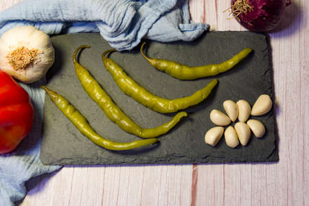 Still life snacks, tapas, chilli peppers, garlic, tomatoes, onions and garlic.の写真素材