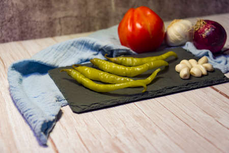 Still life snacks, tapas, chilli peppers, garlic, tomatoes, onions and garlic.の写真素材