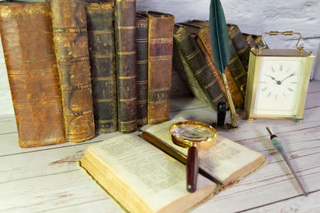 Antique watch along with antique books and vintage writing pen.の写真素材