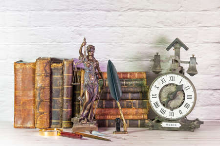 Antique watch along with antique books and vintage writing pen.の写真素材