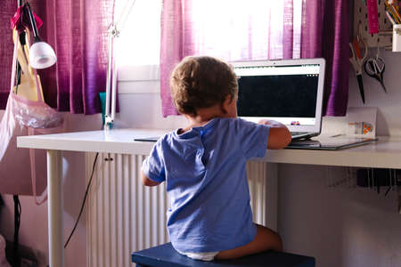 young child watching videos on a laptopの写真素材