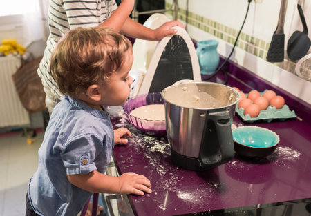 Two children preparing pancakes with a kitchen robot.