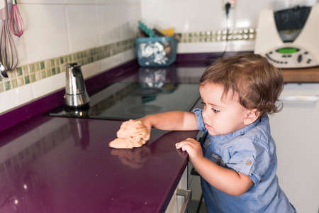 Two children preparing pancakes with a kitchen robot.の写真素材