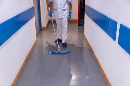 Conceptual photo of a hospital worker cleaning the wardの写真素材