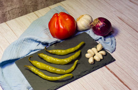 Spanish tapa of beer with chilli peppers, tomatoes and garlic.の写真素材