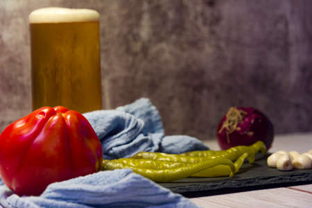 Spanish tapa of beer with chilli peppers, tomatoes and garlic.の写真素材