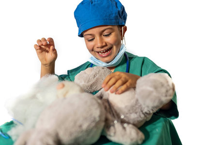 concept of a child's vocation playing doctor-surgeon operating a teddy bear.の写真素材