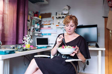 woman making craftsmanship, polymer clay and silver jewelery in the workshop.の写真素材