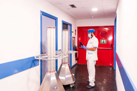 cleaning staff performing disinfection and hygiene work in hospital facilitiesの写真素材
