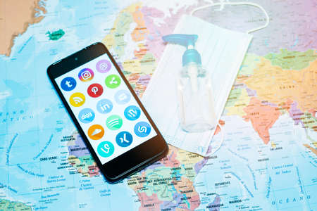 Madrid, Spain 10/2020 mobile phone with the main social media with a world map backgroundのeditorial素材