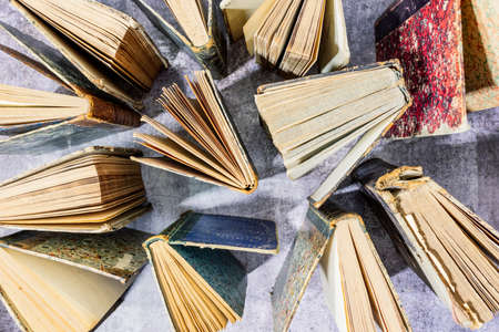 top view of old books on cement backgroundの写真素材