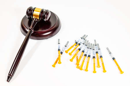 Judge's deck with several syringes on a white background. SELECTIVE FOCUS.の写真素材