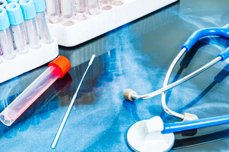 PCR TEST ON A TAC BASE AND A STETHOSCOPE. SELECTIVE FOCUS.の写真素材