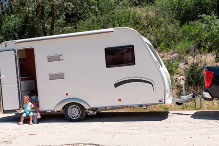 Happy siblings enjoy caravan holidaysの写真素材