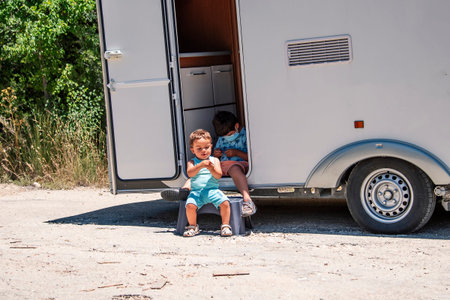 Happy siblings enjoy caravan holidaysの写真素材