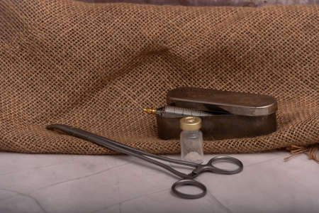 Antique glass syringe with reusable needle. background on brick wall.の写真素材