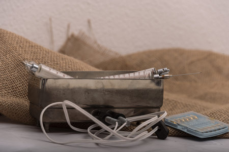 Antique glass syringe with reusable needle. background on brick wall.の写真素材