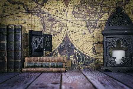 still life composed of antique books, camera and clock on a background of a classic map.の写真素材