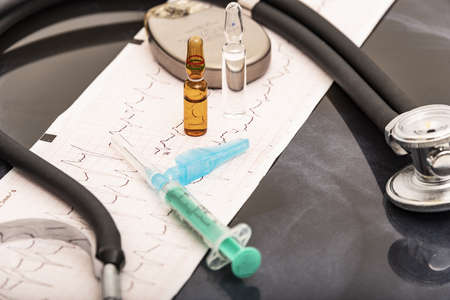 still life of a stethoscope with pacemaker battery and medical objectsの写真素材