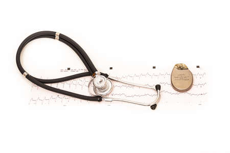 TWO PACEMAKER BATTERIES SURROUNDED BY A STETHOSCOPE WHITE BACKGROUNDの写真素材
