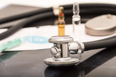 still life of a stethoscope with pacemaker battery and medical objectsの写真素材