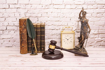 judge's gavel and symbol of justice whit book and clock.の写真素材