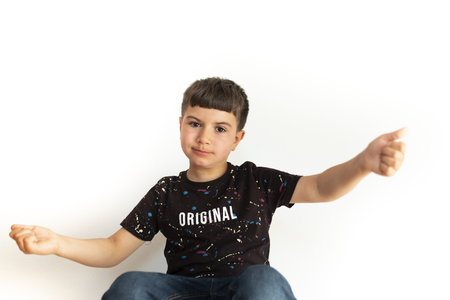 Caucasian child expressing approval with open arms on white backgroundの写真素材