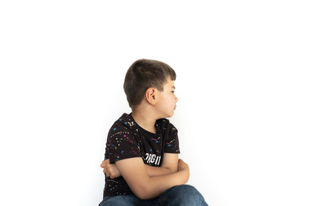 Caucasian children grimacing angrily against white background.の写真素材