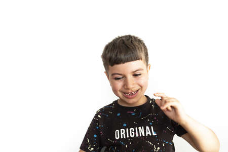 caucasian child expressing amusement with homework on white backgroundの写真素材