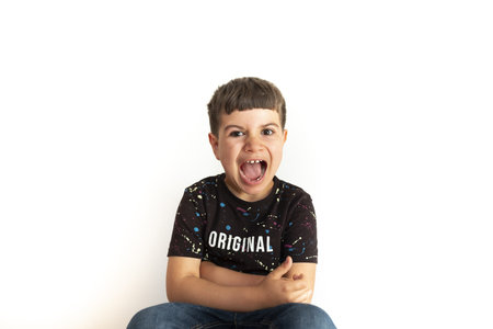caucasian boy furious and screaming on a white background