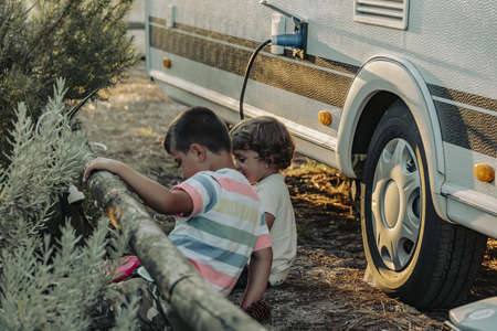 Two Boys In A Caravan playing in the natureの写真素材