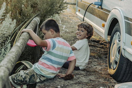 Two Boys In A Caravan playing in the natureの写真素材