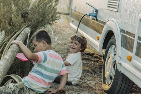 Two Boys In A Caravan playing in the natureの写真素材