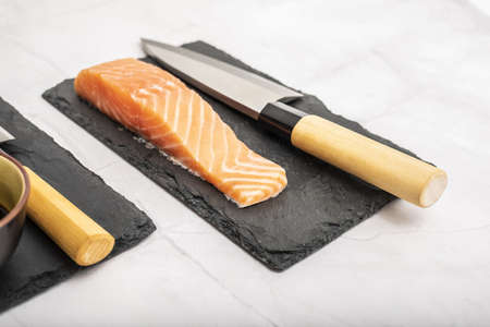 Preparation of sushi with salmon loins. Traditional Japanese cuisineの写真素材