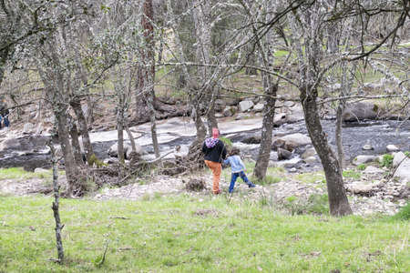 A single-parent family strolls through nature, avoiding crowds of peopleの写真素材