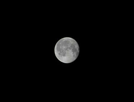 Close-up of full moon on black backgroundの写真素材